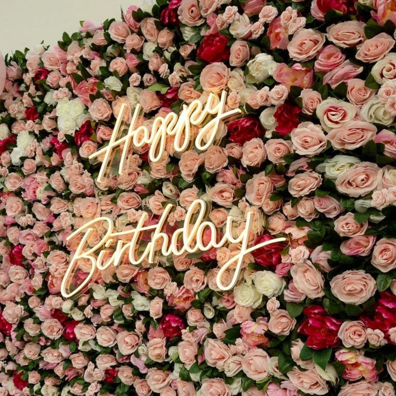 Happy Birthday LED neon sign on greenery wall