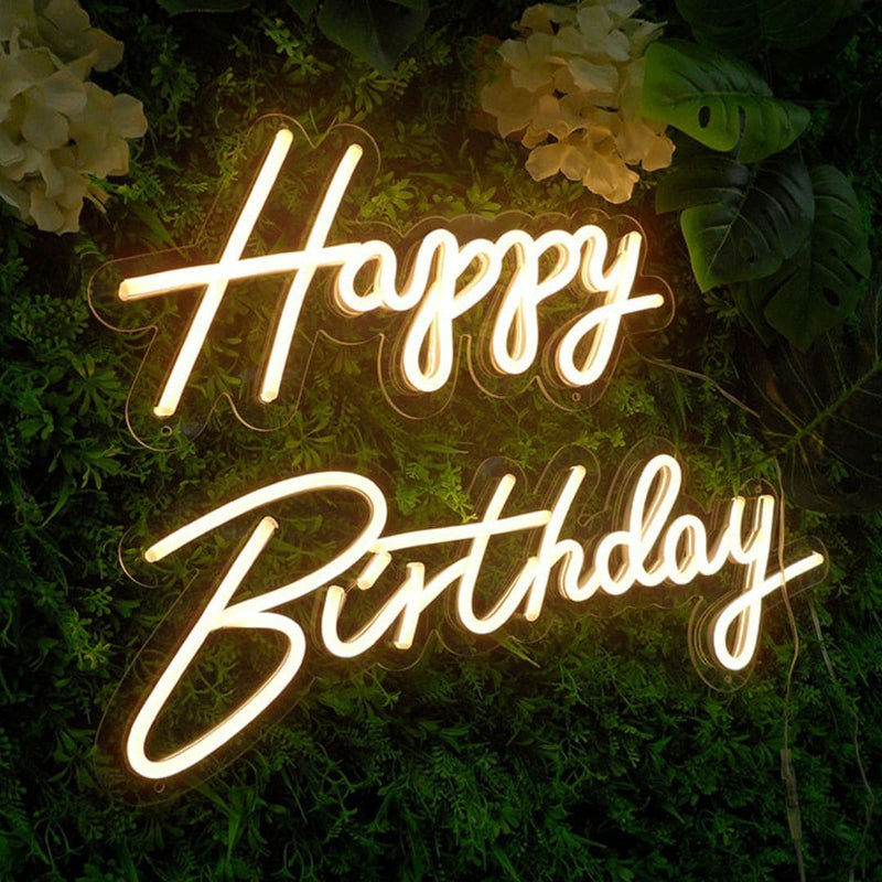 Happy Birthday LED neon sign on greenery wall